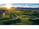 Scenic golf course view featuring lush green grass, sand traps and mountain views in the background at 11300 N Casa Dega Dr # 1005, Surprise, AZ 85388