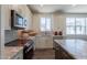 Gourmet kitchen featuring stainless steel appliances, granite counters and modern backsplash at 11300 N Casa Dega Dr # 1005, Surprise, AZ 85388