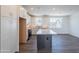 Bright kitchen with stainless steel appliances, granite counters, white cabinets, and a gray kitchen island at 11300 N Casa Dega Dr # 1005, Surprise, AZ 85388