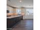 Modern kitchen featuring white cabinets, gray island, stainless steel appliances, and recessed lighting at 11300 N Casa Dega Dr # 1005, Surprise, AZ 85388