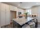 Spacious kitchen with white cabinets, granite countertops and a center island with bar stool seating at 11300 N Casa Dega Dr # 1005, Surprise, AZ 85388