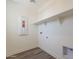 Clean and functional laundry room with ample shelving and connections, ready for efficient organization at 11300 N Casa Dega Dr # 1005, Surprise, AZ 85388