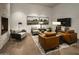 Comfortable living room with a modern fireplace, stylish furniture, and sleek, hardwood floors at 11300 N Casa Dega Dr # 1005, Surprise, AZ 85388