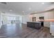 Large, open living room with hardwood floors, a modern kitchen, and lots of natural light at 11300 N Casa Dega Dr # 1005, Surprise, AZ 85388