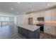 Spacious living area with an open layout, adjacent to a modern kitchen with stainless steel appliances at 11300 N Casa Dega Dr # 1005, Surprise, AZ 85388