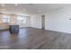 Open floor plan highlights the modern kitchen and spacious living area with wood flooring at 11300 N Casa Dega Dr # 1005, Surprise, AZ 85388