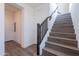 Wood staircase with dark wood handrail and white risers ascending to upper level at 11300 N Casa Dega Dr # 1005, Surprise, AZ 85388