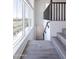 Staircase featuring light gray wood-look flooring and large windows for natural light at 11300 N Casa Dega Dr # 1005, Surprise, AZ 85388