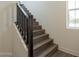 View of staircase with wood treads, modern railing, and in-step lighting at 11300 N Casa Dega Dr # 1005, Surprise, AZ 85388