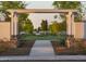 A pathway through a trellis showing the community's manicured lawns and white fences at 11300 N Casa Dega Dr # 1005, Surprise, AZ 85388