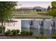 Scenic community water feature with serene waterfalls, surrounded by a lush golf course and mountain views at 11300 N Casa Dega Dr # 1005, Surprise, AZ 85388
