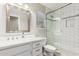 Bright bathroom featuring glass shower, toilet, and modern vanity with granite countertop at 11669 W Pine Mountain Ct, Surprise, AZ 85378