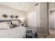 Bedroom with neutral colors, side table, and adjacent ensuite bath at 11669 W Pine Mountain Ct, Surprise, AZ 85378