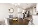 Bright dining area adjacent to the kitchen with gray chairs and a modern light fixture at 11669 W Pine Mountain Ct, Surprise, AZ 85378