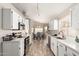 Bright kitchen with stainless steel appliances, white cabinets and adjacent dining area with backyard views at 11669 W Pine Mountain Ct, Surprise, AZ 85378