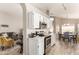 Bright kitchen with stainless steel appliances, white cabinets, and tile flooring at 11669 W Pine Mountain Ct, Surprise, AZ 85378