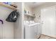 Functional laundry room with modern appliances and ample storage shelves at 11669 W Pine Mountain Ct, Surprise, AZ 85378