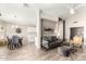 Bright living room with tile flooring that flows into the dining area and kitchen at 11669 W Pine Mountain Ct, Surprise, AZ 85378