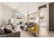 Bright living room with vaulted ceilings, modern decor, and view of the backyard through sliding glass doors at 11669 W Pine Mountain Ct, Surprise, AZ 85378