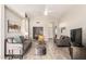 Bright living room with tile flooring, neutral paint, and two gray sofas with yellow accents at 11669 W Pine Mountain Ct, Surprise, AZ 85378