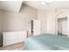 Spacious bedroom featuring tiled floors, modern dresser and ensuite bath at 11669 W Pine Mountain Ct, Surprise, AZ 85378