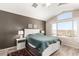 Comfortable main bedroom features a white platform bed, modern decor, and a large window with scenic desert views at 11669 W Pine Mountain Ct, Surprise, AZ 85378