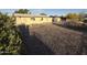 Spacious backyard is gravel-covered with a storage shed and mature trees at 1428 S Palo Verde Dr, Apache Junction, AZ 85120
