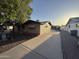 Angle shot of a single-story brick house with large driveway and mature tree at 1428 S Palo Verde Dr, Apache Junction, AZ 85120