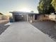Charming single-story brick home featuring a driveway and open garage at 1428 S Palo Verde Dr, Apache Junction, AZ 85120