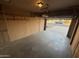 Empty garage with painted brick walls and view to the front yard at 1428 S Palo Verde Dr, Apache Junction, AZ 85120