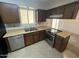 Functional kitchen features dated cabinetry, stainless steel appliances, and natural lighting at 1428 S Palo Verde Dr, Apache Junction, AZ 85120