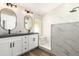 Modern bathroom with dual sinks, quartz countertops, and a stylish marble walk-in shower at 1710 S Aaron --, Mesa, AZ 85209
