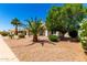 Beautiful single-story home with mature trees, desert landscaping and a well-maintained front yard at 1710 S Aaron --, Mesa, AZ 85209