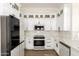 Bright kitchen features stainless steel appliances, white cabinets, and quartz countertops at 1710 S Aaron --, Mesa, AZ 85209