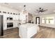 Modern kitchen with stainless steel appliances, a large island, and sleek white cabinets at 1710 S Aaron --, Mesa, AZ 85209