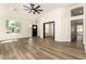 Bright living room boasts wood floors, fresh paint, a modern fan, and lots of natural light at 1710 S Aaron --, Mesa, AZ 85209