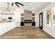Cozy living room open to the kitchen features a modern fireplace, wood floors, and fresh paint at 1710 S Aaron --, Mesa, AZ 85209