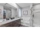 Modern bathroom with dual sinks, soaking tub, and walk-in shower at 17178 W Buchanan St, Goodyear, AZ 85338