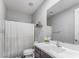 Clean bathroom with a shower featuring a curtain and sleek vanity with a large mirror at 17178 W Buchanan St, Goodyear, AZ 85338