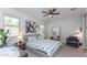 Bright bedroom featuring a cozy bed, ceiling fan, and large windows for natural light at 17178 W Buchanan St, Goodyear, AZ 85338