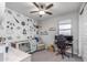Bedroom with space themed wall paper, crib, chair, and desk area at 17178 W Buchanan St, Goodyear, AZ 85338