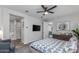 Comfortable bedroom with en-suite bathroom, ceiling fan, and views to the living room at 17178 W Buchanan St, Goodyear, AZ 85338