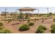 Wide view of the community park's playground with modern equipment and shaded seating areas at 17178 W Buchanan St, Goodyear, AZ 85338