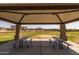 Shaded picnic area with tables offers a place to relax and enjoy views of the community green space at 17178 W Buchanan St, Goodyear, AZ 85338