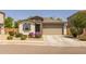 Charming single-story home featuring stone accents, a two-car garage, and manicured landscaping at 17178 W Buchanan St, Goodyear, AZ 85338
