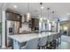 Modern kitchen with white countertop island, stainless appliances, and dark cabinetry at 17178 W Buchanan St, Goodyear, AZ 85338