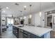 Modern kitchen featuring a large island with quartz countertop and pendant lighting at 17178 W Buchanan St, Goodyear, AZ 85338