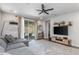 A spacious living room with modern decor, tile flooring, and a sliding glass door to the patio at 17178 W Buchanan St, Goodyear, AZ 85338