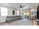 A spacious living room with modern decor, tile flooring, and a sliding glass door to the patio at 17178 W Buchanan St, Goodyear, AZ 85338