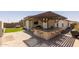 Outdoor kitchen, bar, and entertainment area with seating at 17178 W Buchanan St, Goodyear, AZ 85338
